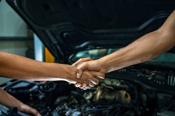 Handshake over an open engine bay